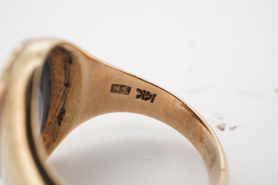 An opal doublet signet ring, set with a polished black opal measuring approximately 14.7 x 9 x 2.8mm, within a gold mount, size O, stamped 14K, gross weight approximately 6 grams